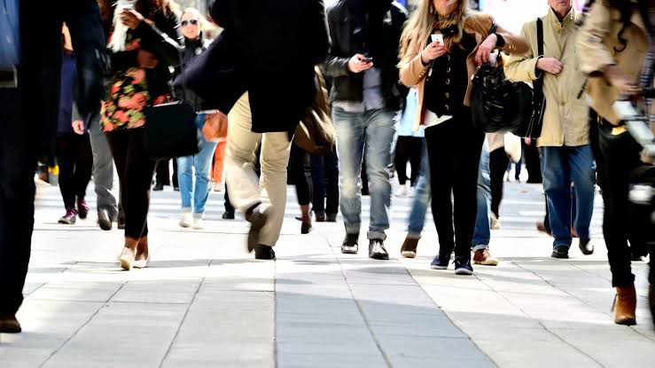 Pedestrians walking through a busy public space
